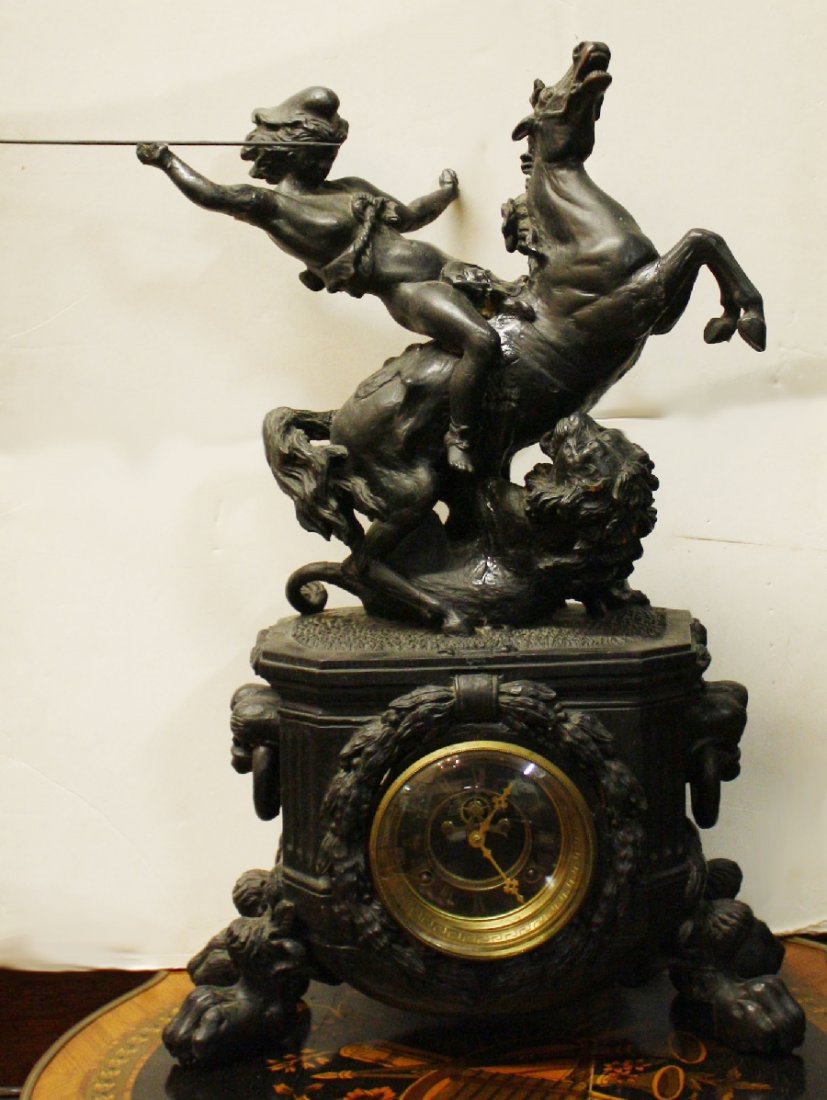 Heavily carved wood mantel clock- Waterbury Clock Co: Depicting a warrior on horseback on top of a lion. With lion head rings and hairy paw feet. Late 19th century. Movement is marked Waterbury Clock Co. Connecticut. 27 1/2"h x 17 3/4"l x 9 1/2"d