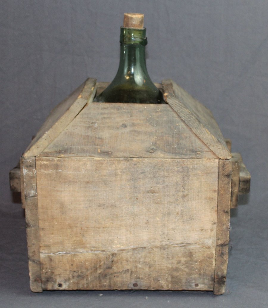 French blown glass demi john bottle in wood box: A French blown glass demi john wine bottle in wooden crate. 16 1/2"h x 12"square (box)