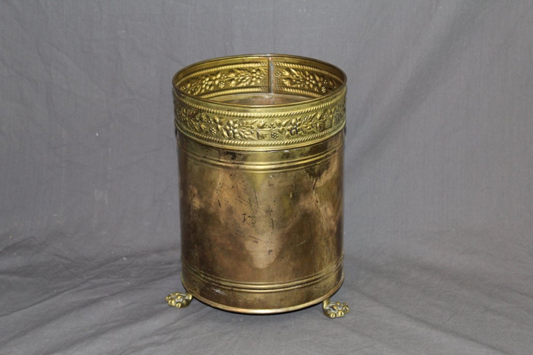 Embossed brass waste bin with paw feet: Embossed brass waste bin with paw feet. Early-mid 20th C. 12.25"h x 9"diaProvenance: Estate of Arthur Smith, New York.
