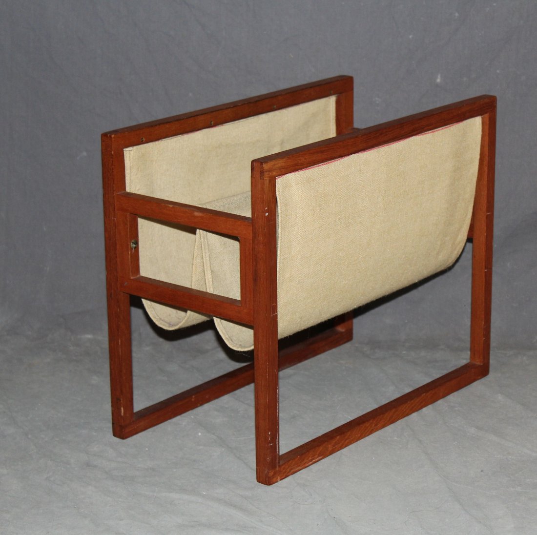 Vintage teak & canvas magazine stand: Vintage teak & canvas magazine stand. 15"h x 18"w x 9.75"dProvenance: Estate of Arthur Smith, New York.