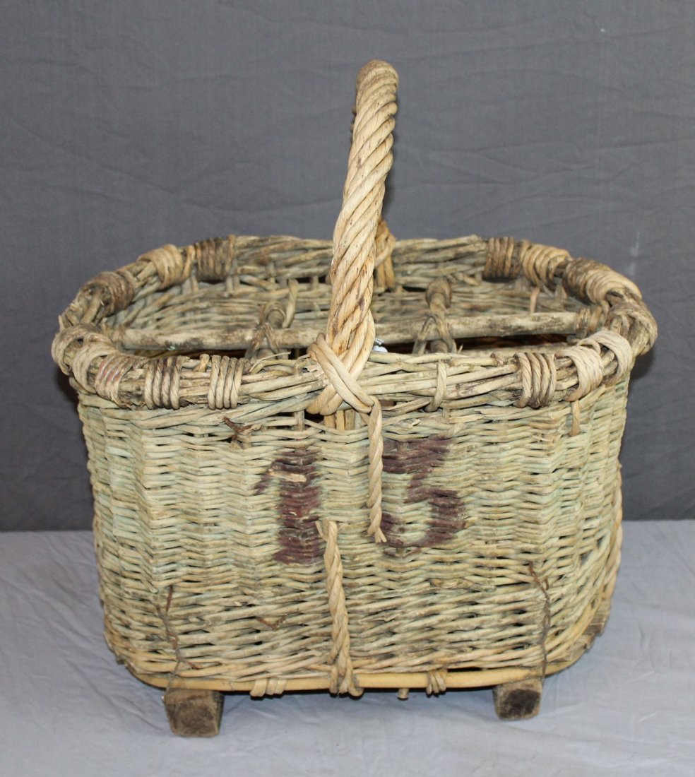 French wicker wine bottle basket: French wicker wine bottle carrying basket. Holds 6 bottles. Early 20th century. 18 1/4"h x 18"w x 13 1/2"d
