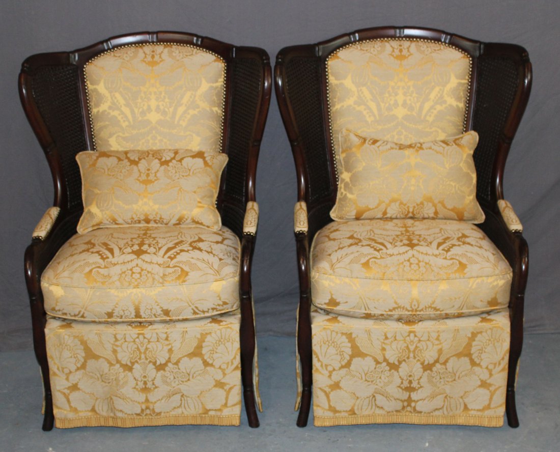 Pair of Gary Riggs wing back chairs with cane: A pair of Gary Riggs wing back chairs with double cane and custom upholstery. 42"h