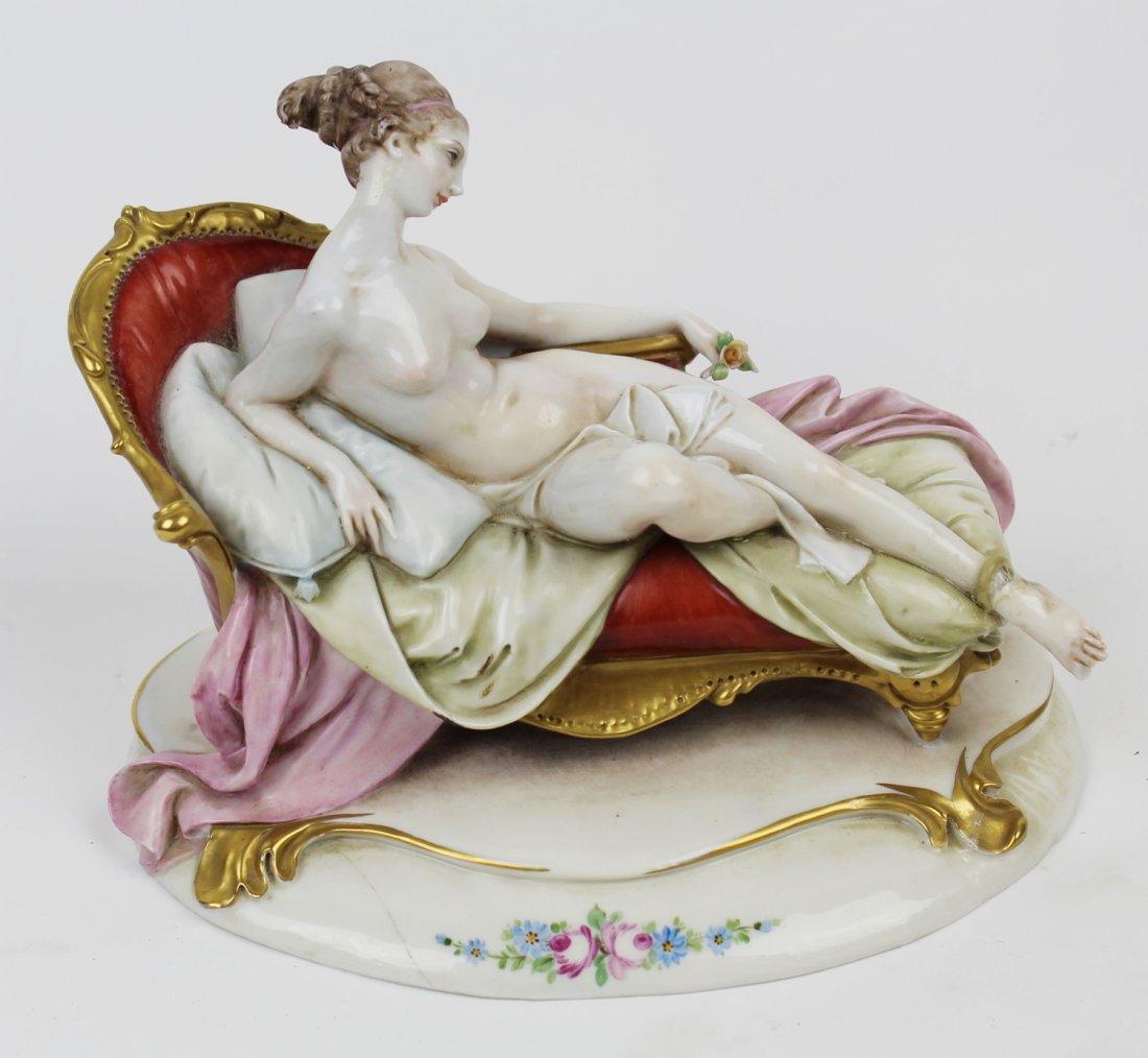 Antique Capodimonte porcelan reclining nude on sofa: Antique Capodimonte porcelain reclining nude on sofa. 8"h x 6 1/2"w x 3 1/2"w