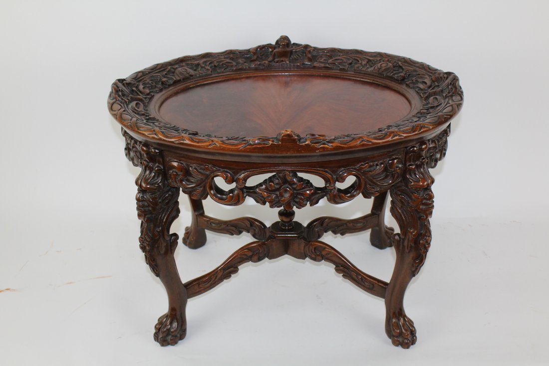 Heavily carved cocktail table with figural masks (1 of 5)