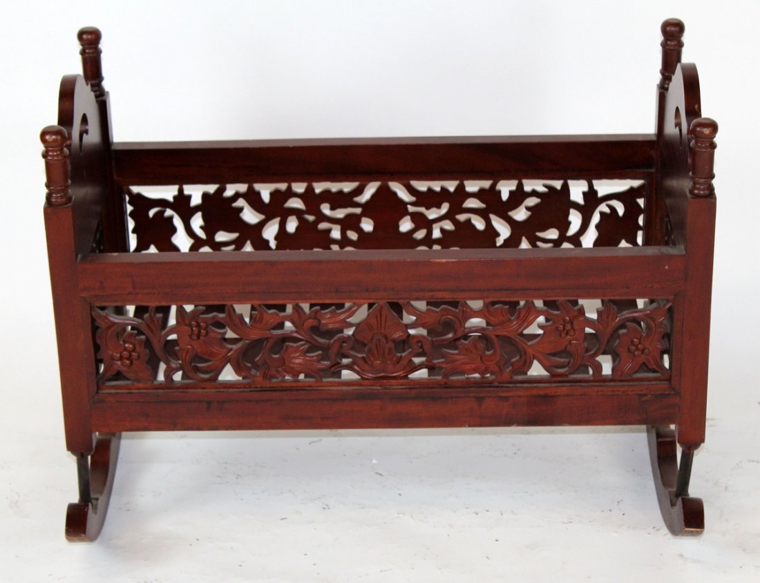 Carved mahogany cradle with floral carving: Carved mahogany cradle with floral carving. 32"w x 24"h x 16"d