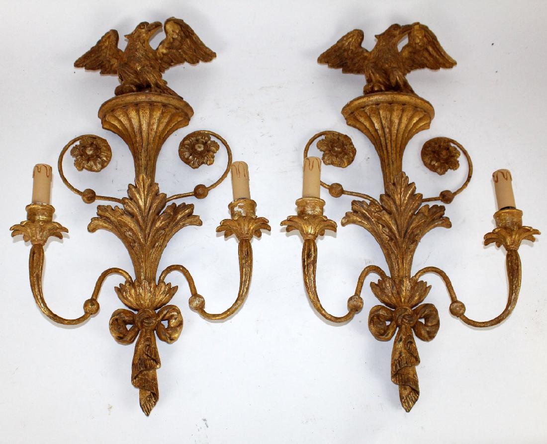 Pair of Italian gilt wood sconces with eagles: Pair of Italian gilt wood sconces with eagles and carved foliate and ribbon detail. 27 1/2"h x 16"w