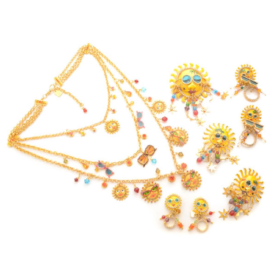 Lunch at the Ritz Couture Costume Sun Theme Jewelry: Lunch at the Ritz Couture Costume Sun Theme Jewelry Suite. Including one unidentified three strand sun with sunglasses motif necklace; one "La Playa Pin" pendant brooch; one pair of sun motif unidenti