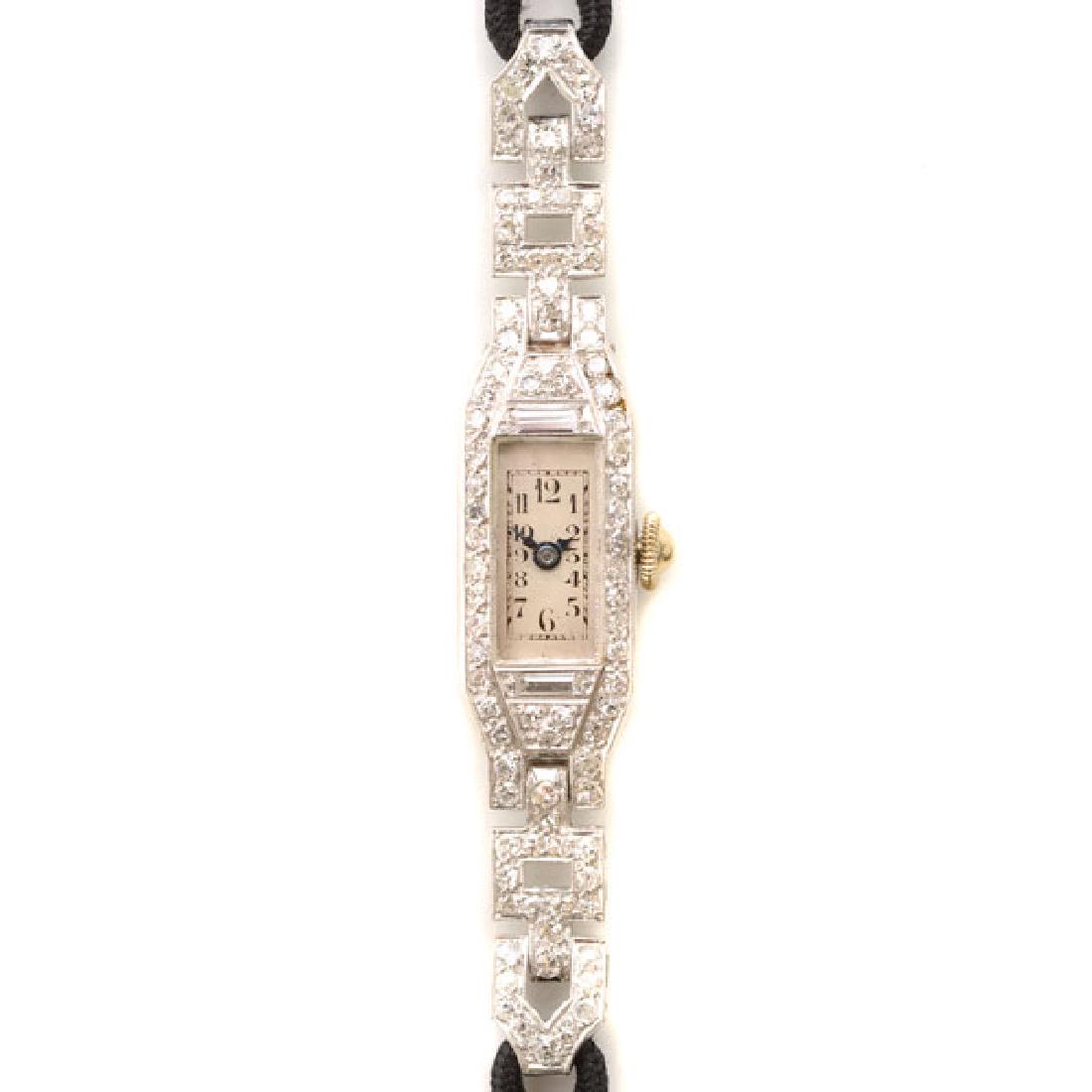 Ladies Art Deco Diamond, Platinum, Nylon Wristwatch.: Ladies Art Deco Diamond, Platinum, Nylon Wristwatch. DIAL: Rectangle, cream, black Arabic numeral hour markers, black outer minutes track, blued arrow style hands. MOVEMENT: Manual wind, jeweled, 211,