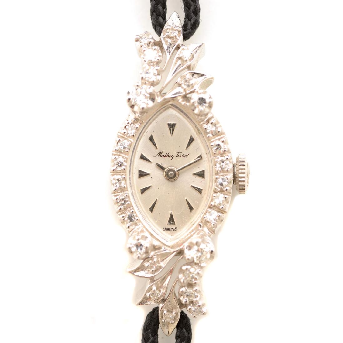 Ladies Mathey-Tissot Diamond, 14k White Gold, Black: Ladies Mathey-Tissot Diamond, 14k White Gold, Black Cord, Metal Wristwatch. {Gross Weight: 8.0 dwts}
