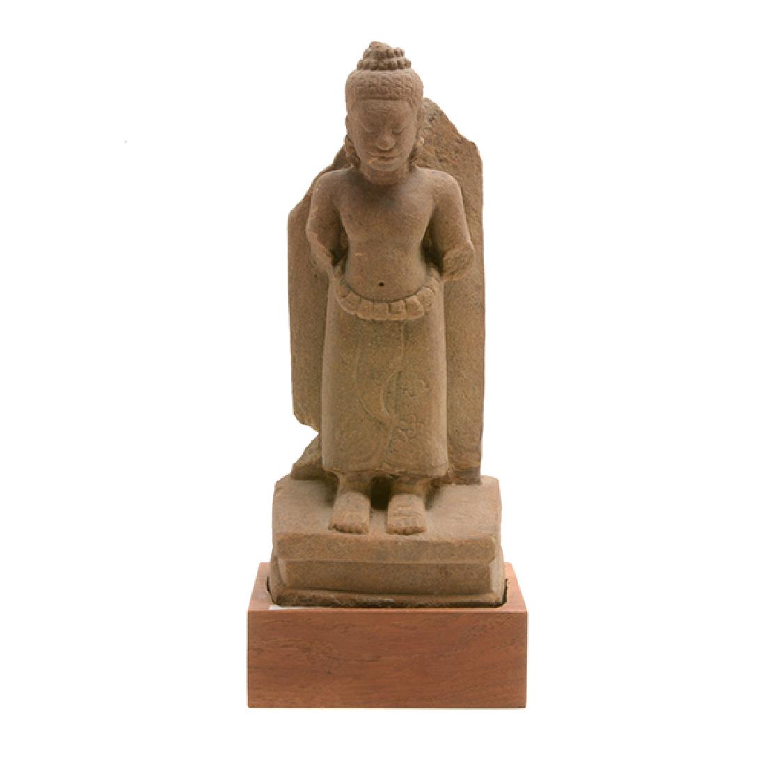 Cambodian Sandstone Figure of Uma, Angkor Period: Khmer Sandstone Figure of Uma Carved with downcast eyes, floral skirtm and hair in decorated top knot, with fitted wood stand. Angkor Period {Height: 10 inches (25.4 cm) excluding stand} [Losses]