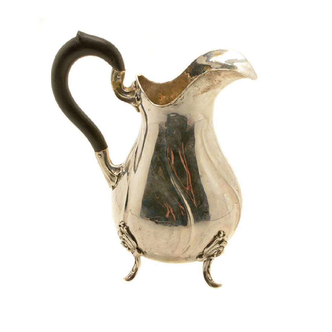 Rococo Revival 830 Standard Silver Pitcher: Rococo Revival 830 Standard Silver Pitcher, The diagonally fluted pear form with a helmet spout and a fitted auricular ebonized wood handle {Total silver weight 15.75 oz; overall height 8 3/4 inches}