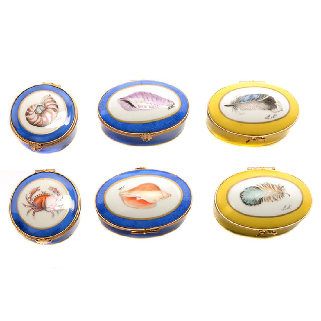 Eleven Limoges Porcelain Decorative Boxes: Eleven Limoges Porcelain Decorative Boxes, Comprising an Eiffel Tower {height 3 inches}, a fruit basket, a small box with a frame on lid, two yellow oval boxes with feathers {length 2 5/8 inches}, a c