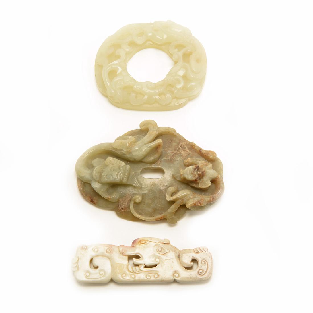 Three Jade 'Chilong' Carvings , Qing Dynasty: Three Jade 'Chilong' Carvings The first is a bi disc of even white stone deeply carved and pierced with a pair of sinuous chilong dragons perched atop, the reverse with archaistic shallow bosses; the