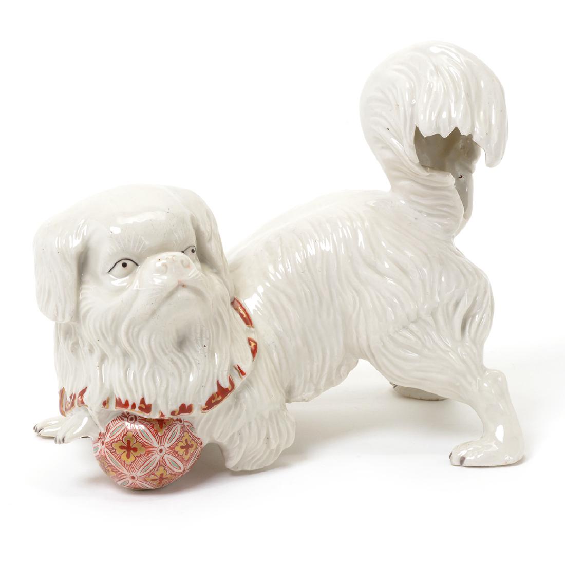 Japanese Kutani Blanc de Chine Porcelain Model of: Japanese Kutani Blanc de Chine Porcelain Model of Pekinese Dog with Puzzle Ball, The dog white save the puzzle ball and the collar, both enameled in a Kakeimon palette {Height to tail tip 7 1/2 inches