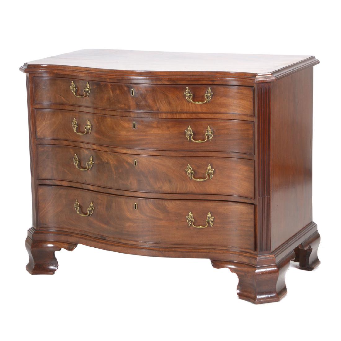George III Mahogany Serpentine Chest of Drawers.: George III Mahogany Serpentine Chest of Drawers. The serpentine shaped top with cove molded edge above four cockbeaded drawers flanked by stop fluted canted corners and raised on ogee bracket feet, br