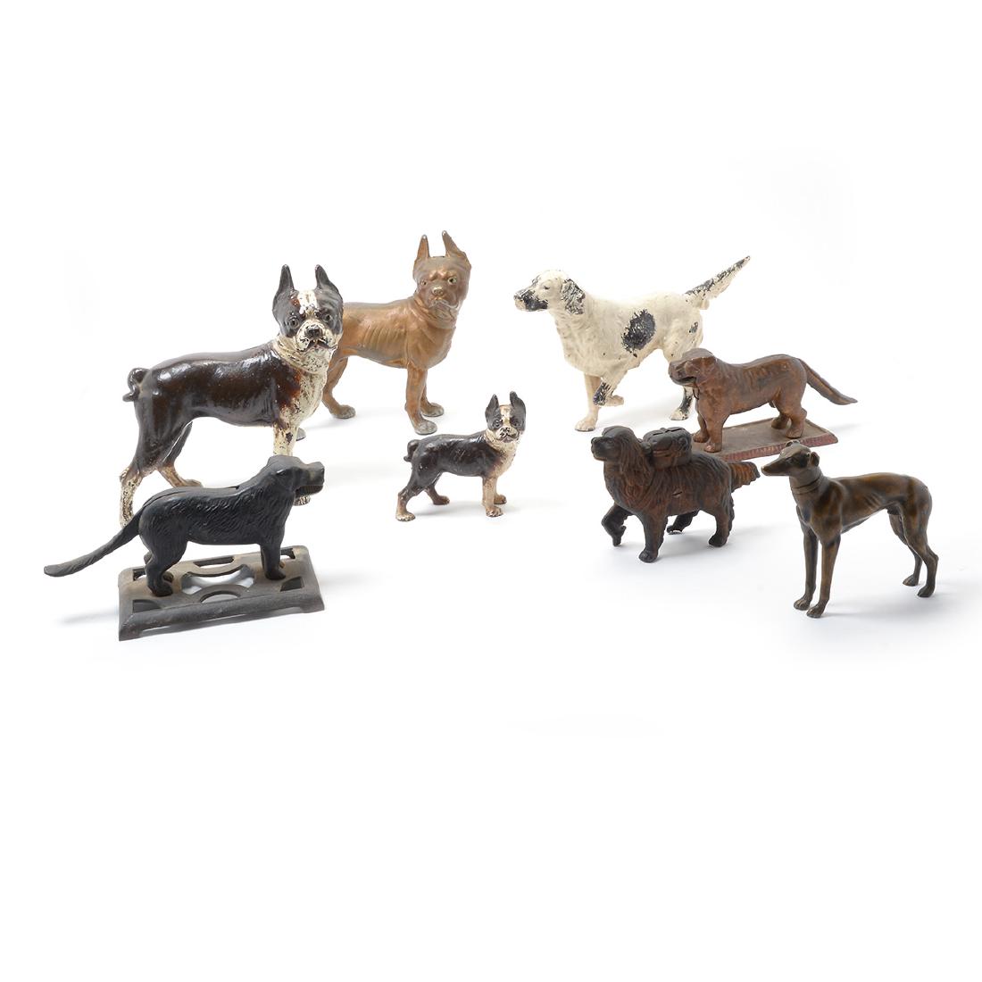 Lot of Seven Cast Iron Figures of Dogs, and Greyhound: Lot with Seven Cast Iron Figures of Dogs, and Greyhound figure. Including three bulldog doorstops, two nutcrackers, a Setter doorstop, a St.Bernard bank, and a Greyhound figure. {Dimensions of largest