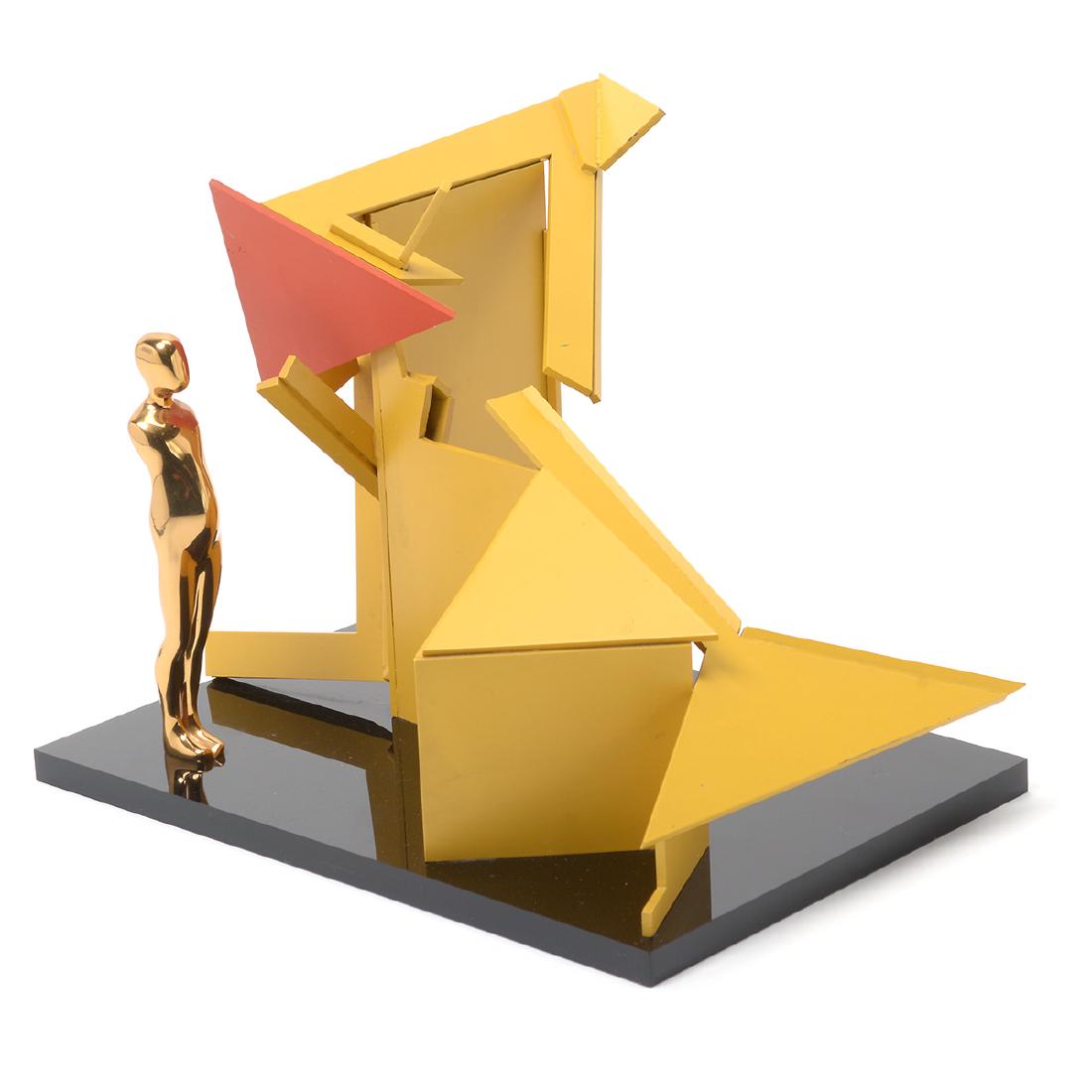 Ernest Trova "Figure with Construction" sculpture: ERNEST TROVA (American 1927-2009) "Figure with Construction" Metal on Lucite base. 8 1/2 x 11 1/2 x 8 inches. Monogrammed, numbered: 44/99 and dated 1987 on the bottom of the Lucite base.