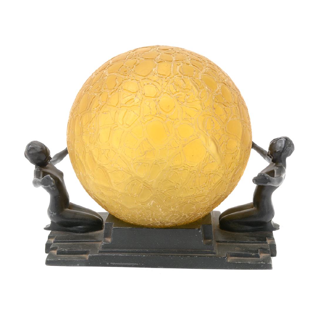 Frankart Ebonized Metal Double Figural Lamp: Frankart Ebonized Metal Double Figural Lamp. Rectangular stepped base with nude female figures at either end, arms outstretched, and a gold glass sphere in the center. {Dimensions: 9 x 10 x 7 1/2 inch