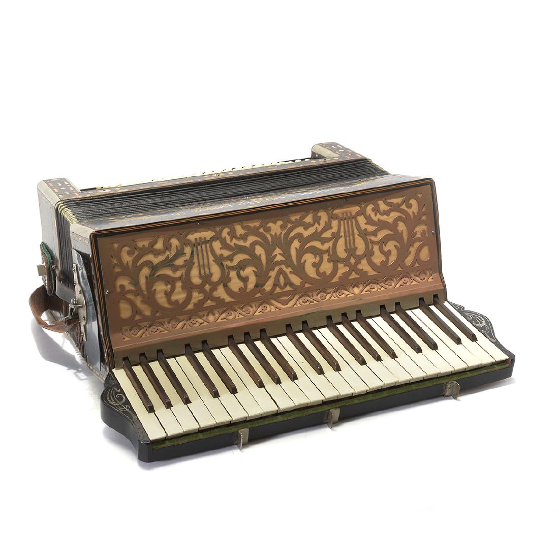 Guerrini & Co. Accordion: Guerrini & Co. Accordion. A full sized accordion with mother of pearl borders, scrolling and eagles. San Francisco, CA. {Dimensions: 18 x 17 1/2 x 9 1/2 inches.}