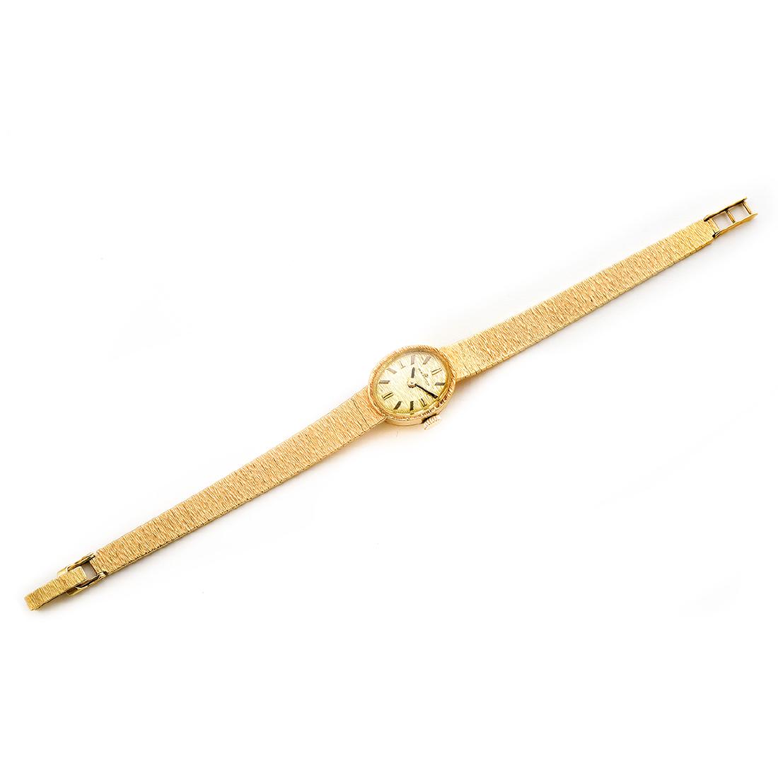 Ladies Bucherer 18k Yellow Gold Wristwatch.: Ladies Bucherer 18k Yellow Gold Wristwatch. DIAL: Oval, gold textured, gold and black index hour markers, black baton hands, Bucherer. MOVEMENT: Manual wind, seventeen (17) jewels, adjusted three (3)
