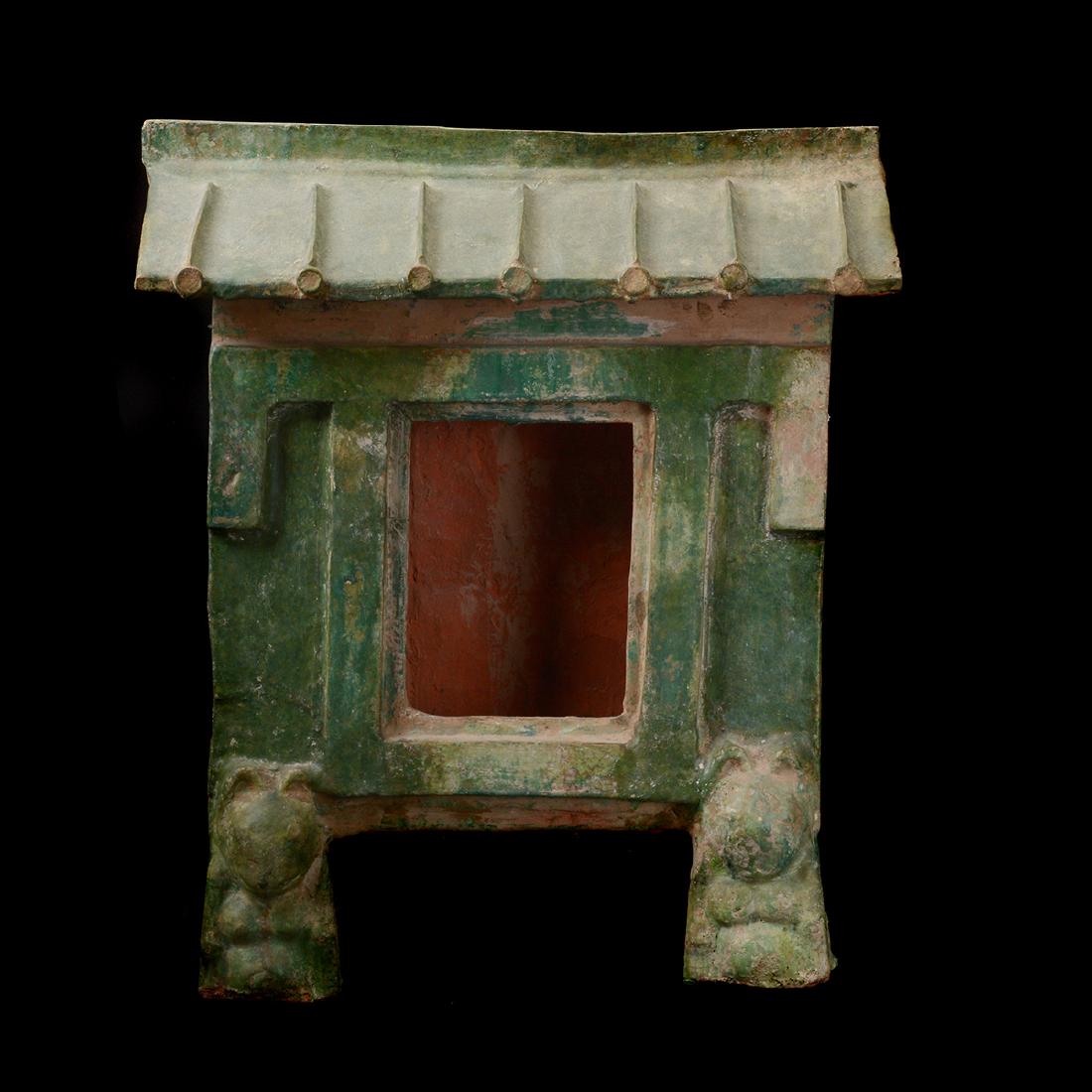 Green Glazed Pottery Model of a Building, Han Dynasty: Green Glazed Pottery Model of a Building. The structure is raised upon bear-form feet. Han Dynasty. {Height: 20 inches (50.8 cm)}. [Losses, restoration to one foot].
