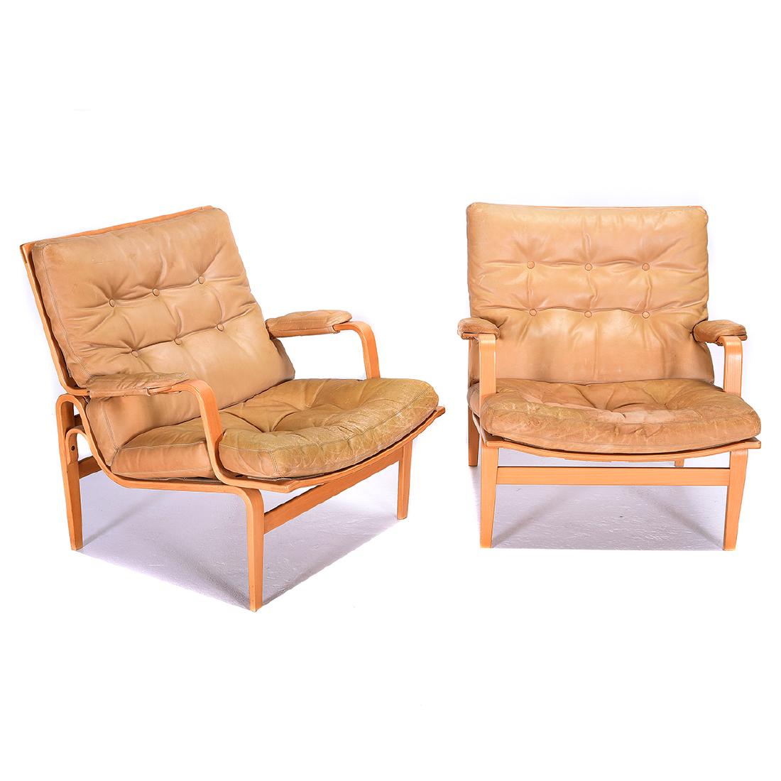 Pair of Bruno Mathsson "Ingrid" Chairs: Pair of Bruno Mathsson "Ingrid" Chairs. Mid century modern open armchairs with laminated beechwood frames and beige tufted leather upholstery. Bruno Mathsson by Dux burned onto rear leg stretcher. Swe