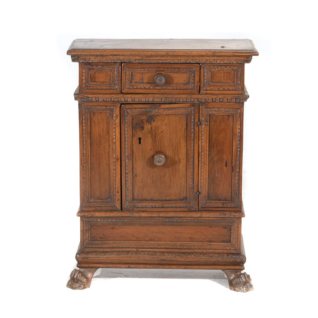 Italian Baroque Walnut Credenza: Italian Baroque Walnut Credenza. Rectangular surface with molded edge crowning a single drawer set over a two door cabinet resting on paw feet. Tuscany, Italy. Early 17th century. {Approximate dimensi
