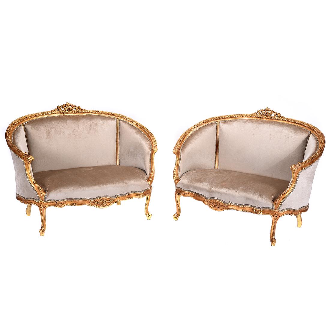 Pair of Louis XV Style Carved Giltwood Upholstered: Pair of Louis XV Style Carved Giltwood Upholstered Settees. {Approximate dimensions: 49 1/2 wide x 30 deep x 38 inches tall.} Condition: Some small stains to upholstery. Minor losses to gilt.