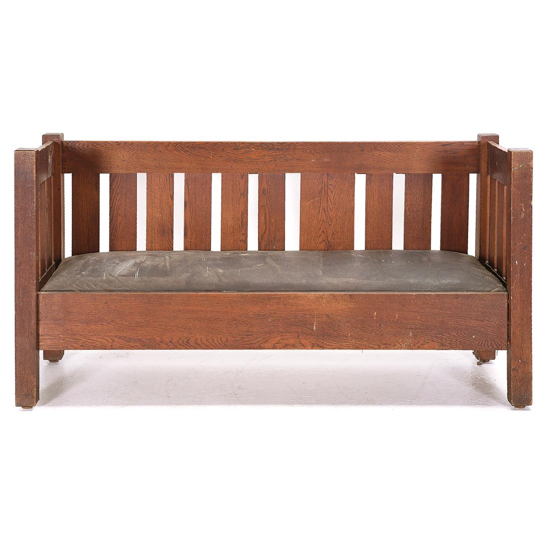 Stickley Style Arts and Crafts Oak Even Arm Settee: Stickley Style Arts and Crafts Oak Even Arm Settee. Leather upholstered seat. {Approximate dimensions: 35 high x 72 wide x 24 inches deep.} Condition: Heavy wear to leather. Minor losses to back. Gene