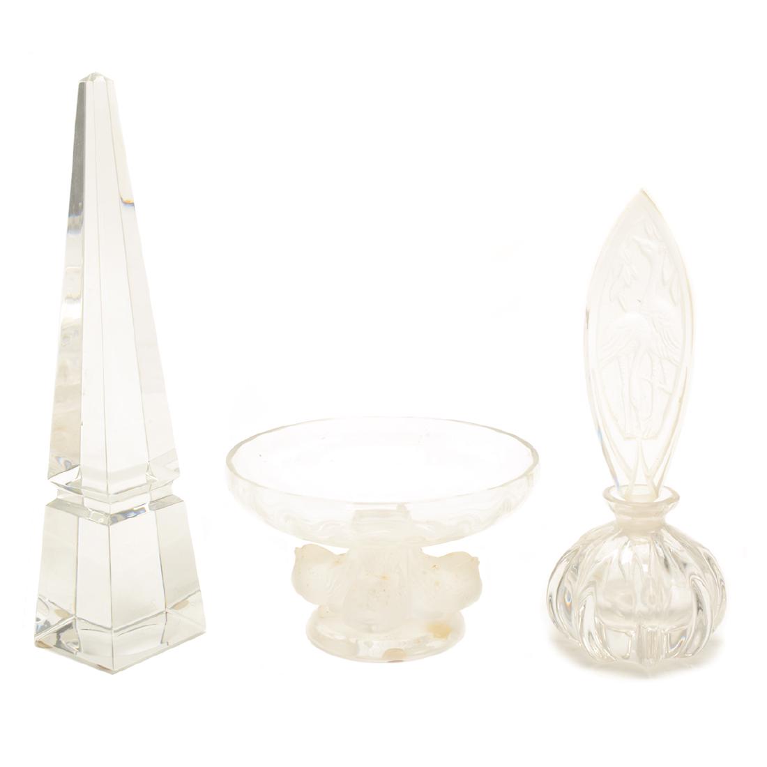 Collection of Three Crystal Articles: Collection of Three Crystal Articles. Comprising a Baccarat crystal obelisk {height 10 inches}, Lalique "Sparrow" compote {diameter 5 5/8 inches}, and a perfume bottle with a flamingo stopper {diamete
