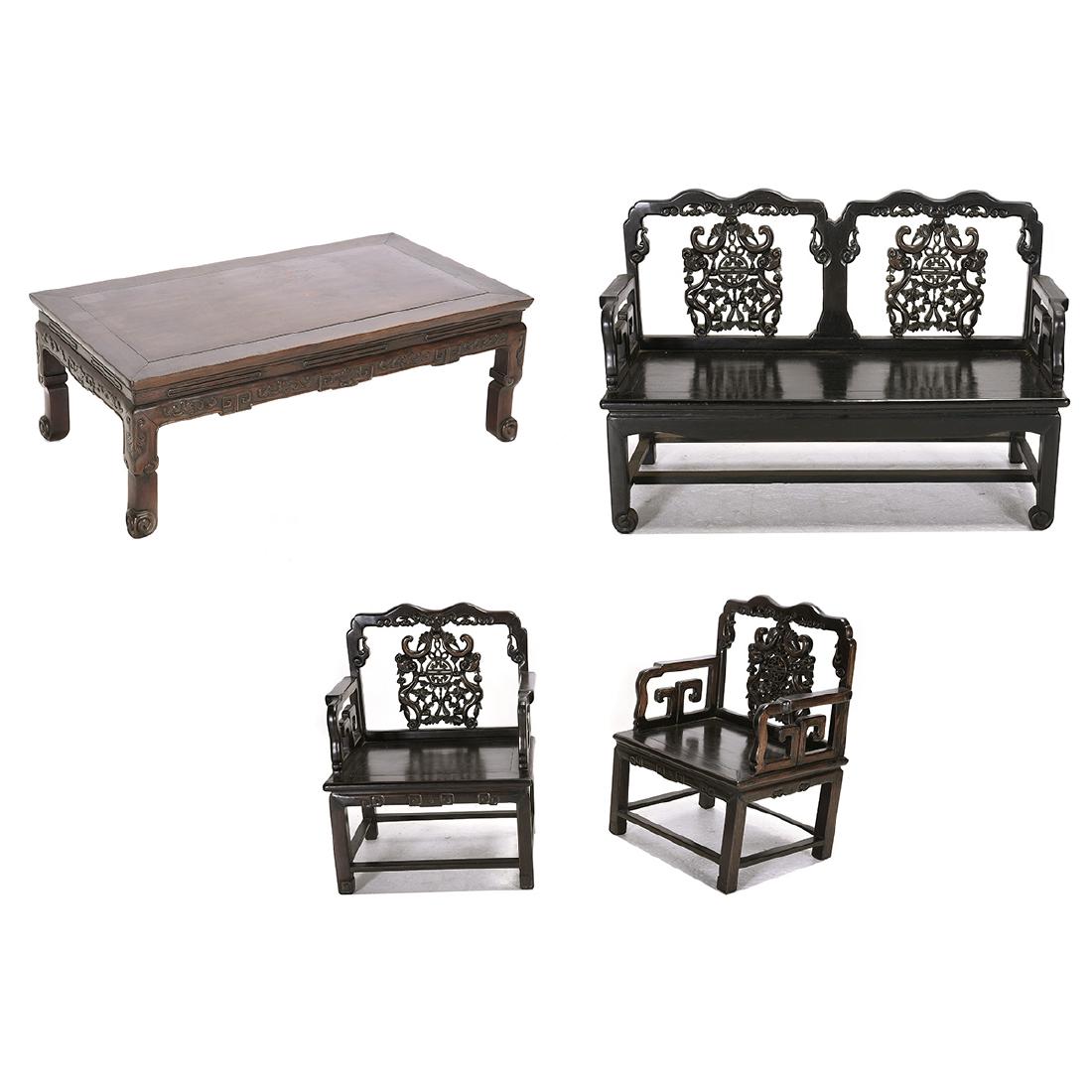 Carved Rosewood Living Room Suite*: Carved Rosewood Living Room Suite*. Comprising a pair of arm chairs, low table, and a settee. {Settee: 32 1/2 x 47 x 18 inches (82.6 x 119.4 x 45.7 cm)}. [Abrasions, aged cracks].