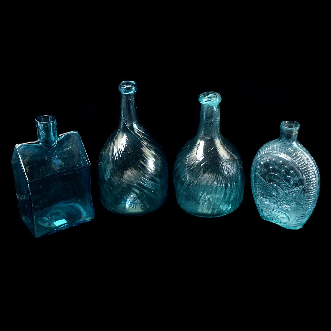 American Blown Glass Bottles: American Blown Glass Bottles Group of four comprising E.G. Booz's Old Cabin Whiskey, Philadelphia, a flask with raised eagle, and two swirl-pattern bottles. 19th century. {Approximate dimensions large