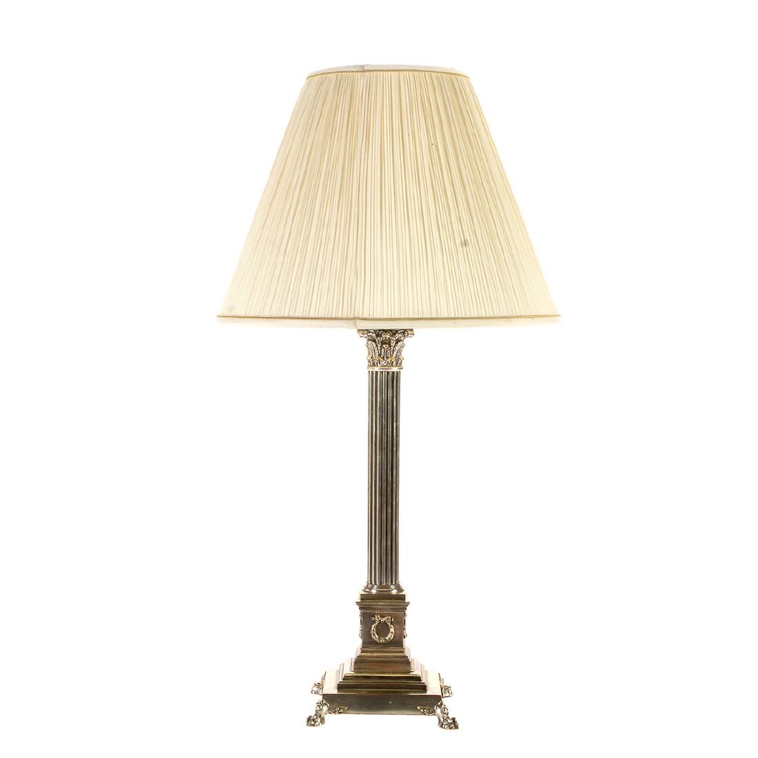 Silver Plate Corinthian Column Form Table Lamp: Silver Plate Corinthian Column Form Table Lamp. Set on a base with four claw feet. Comes with a white cone form shade with gold trim. {Approximate dimensions without shade: 32 1/2 high x 8 inches wide