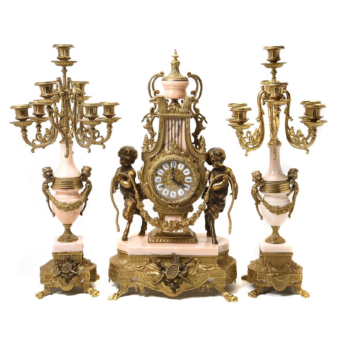 Franz Hermle Italian Baroque Style Bronze and Marble: Franz Hermle Italian Baroque Style Bronze and Marble Clock Garniture. Clock with a seven-light candelabra pair. Gilt bronze and pink marble with enameled numbers on the dial. Two bell chimes. Franz He
