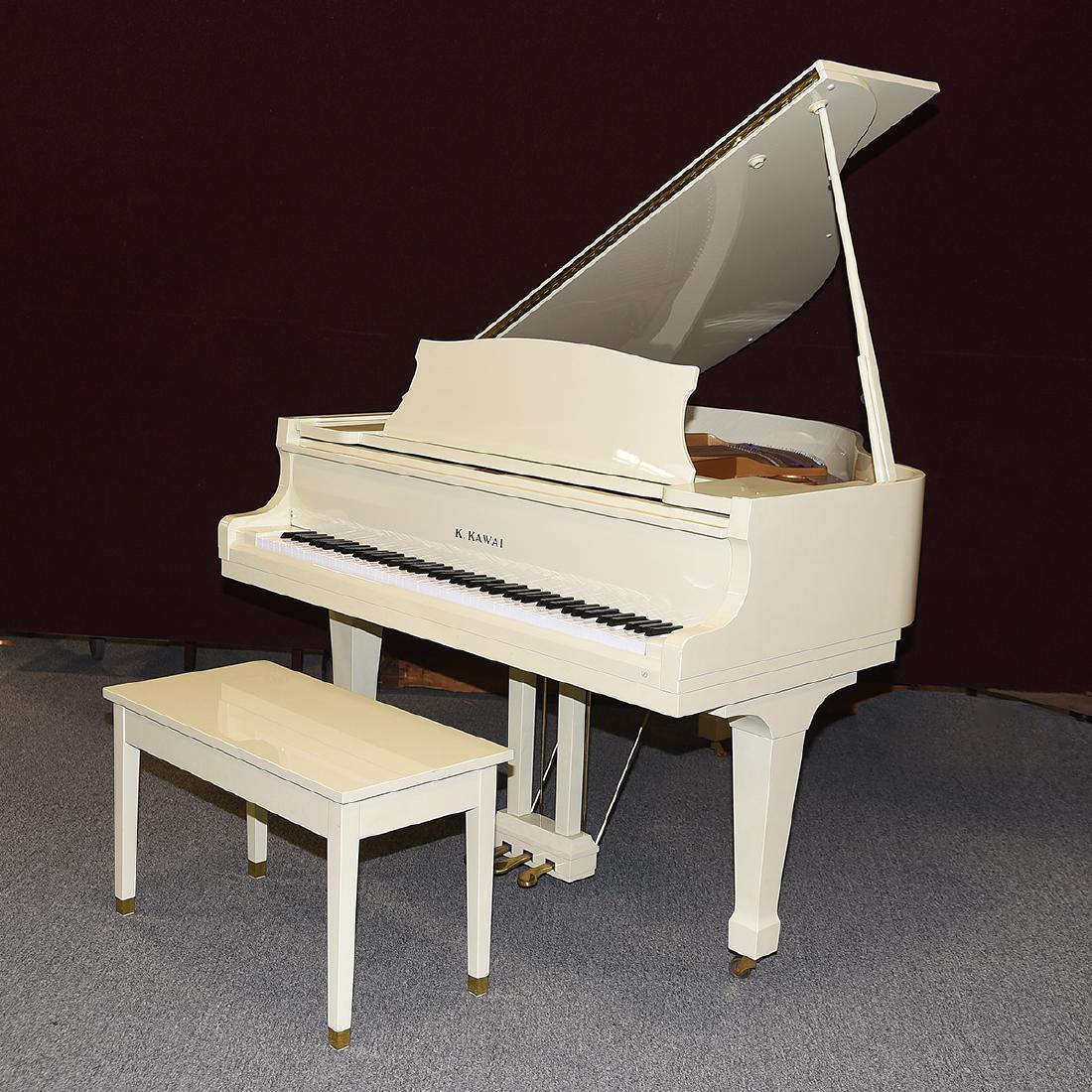 K. Kawai Baby Grand Piano in White.: K. Kawai Grand White Piano with a Bench. With a matching bench. Brass pedals and brass capped feet on the bench. Purple felt where appropriate. Serial number 1655350. Japan. {Approximate dimensions: 7