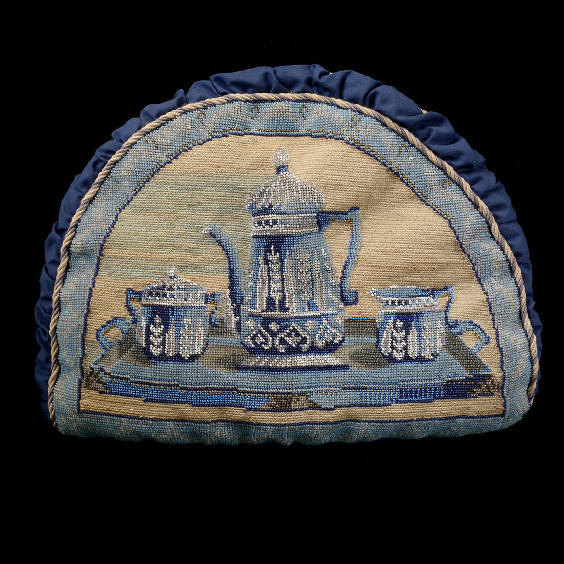 Fine Edwardian Blue & White Hand-Sewn Beadwork Tea Cozy: Fine Edwardian Blue & White Hand-Sewn Beadwork Tea Cozy. Blue fabric with three piece tea set beadwork depicted on each side framed by beige and brown twisted piping. Early 20th century. {Approximate