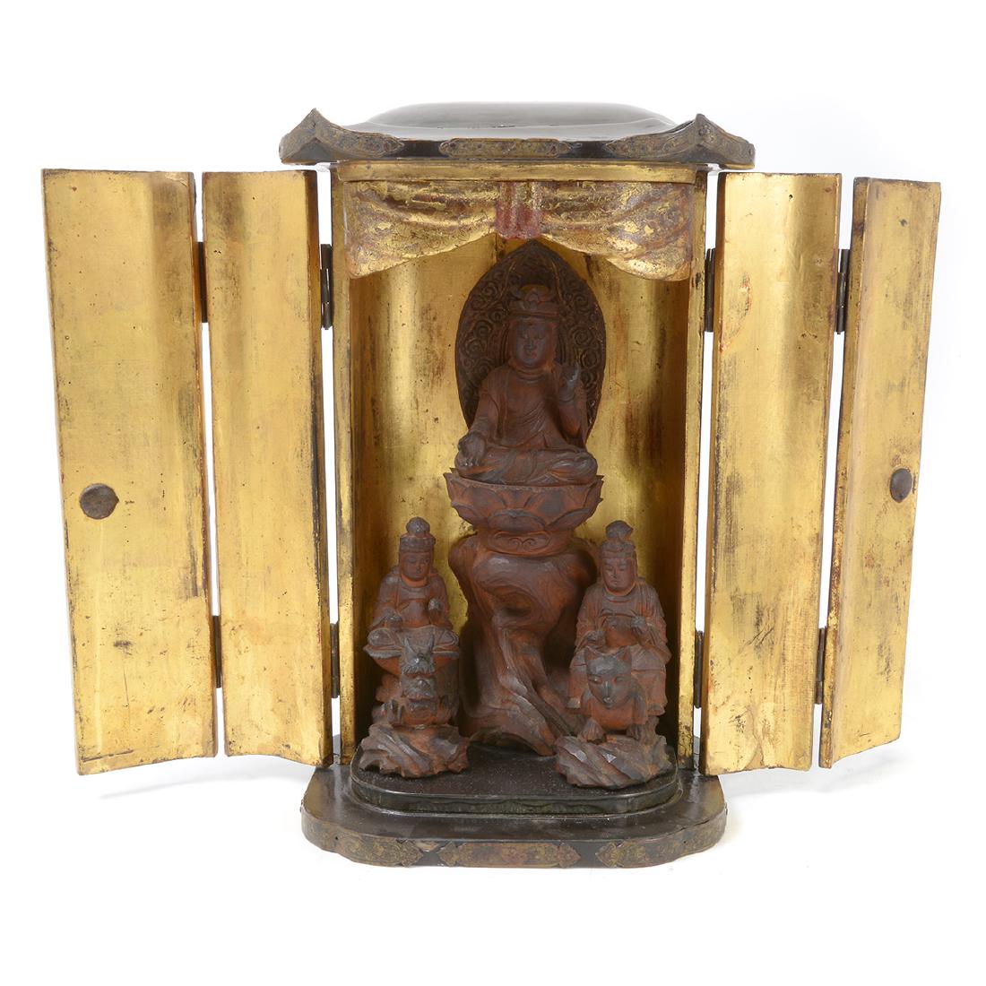 Small Japanese Gilt-Lacquered Traveling Shrine: Small Japanese Gilt-Lacquered Traveling Buddhist Shrine. The shrine with hinged double doors opening to reveal a robed figure seated upon a carved tiered lotus stand, with two attendants seated on bea