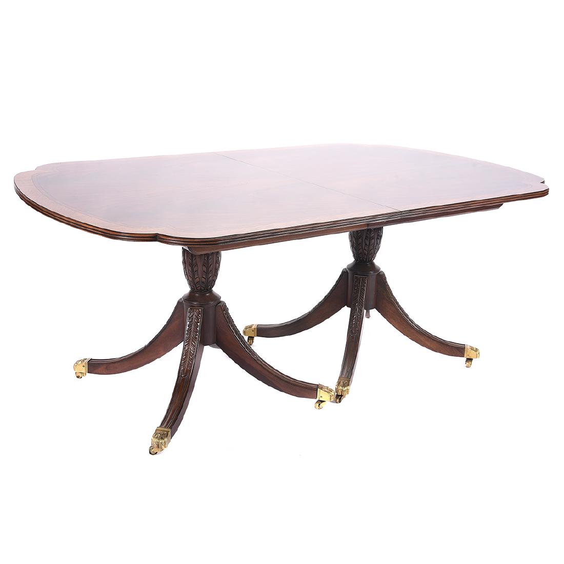 EJ Victor Mahogany Dining Table: EJ Victor Georgian Style Mahogany Dining Table. Mahogany surface with inlay banded border and a walnut outer border, with recessed corners and molded edge, set on a double pedestal base each acanthus 