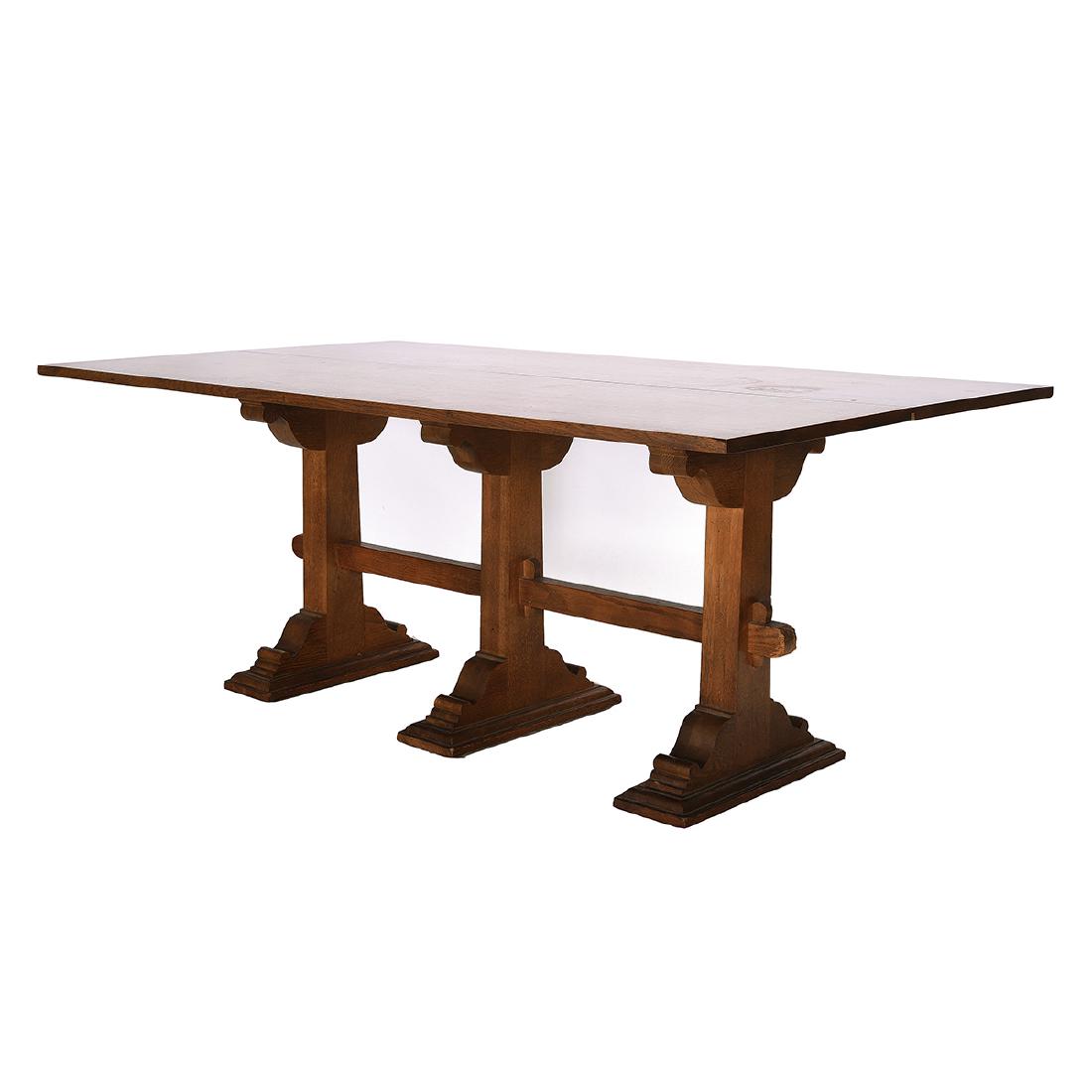 Drexel Arts and Crafts Style Oak Trestle Table: Drexel 'Guildhall' Arts and Crafts Style Oak Trestle Table. With a top that unfolds along the vertical orientation to double the width. Set on three wide footed legs. Drexel markings on the underside.