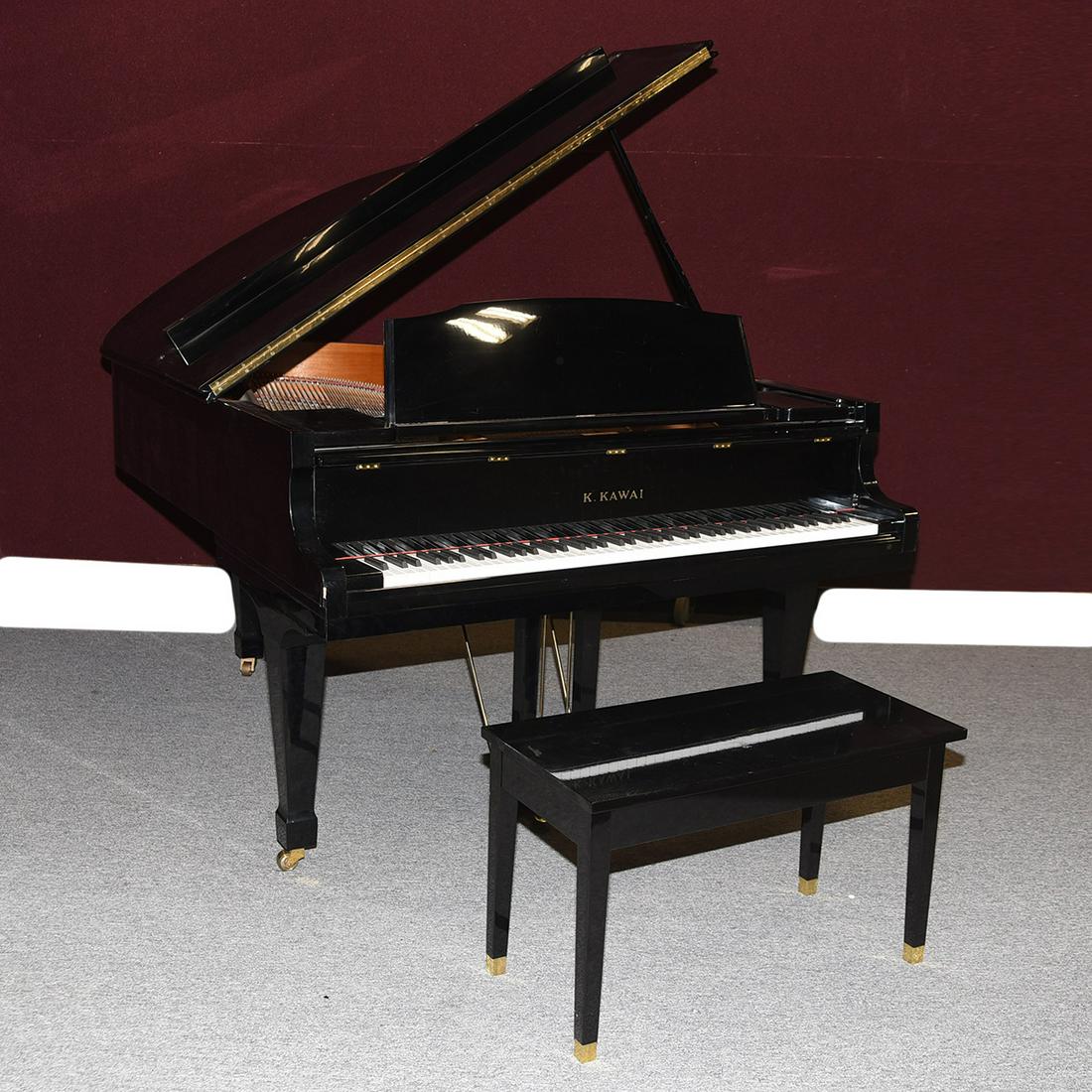 K. Kawai Ebonized Grand Piano, with Bench.: K. Kawai GS-30 Ebonized Grand Piano, with Bench. GS-30 model; Black lacquer exterior, red felt where appropriate, brass pedals and casters. {Approximate dimensions: Piano with raised cover 72 high x 5