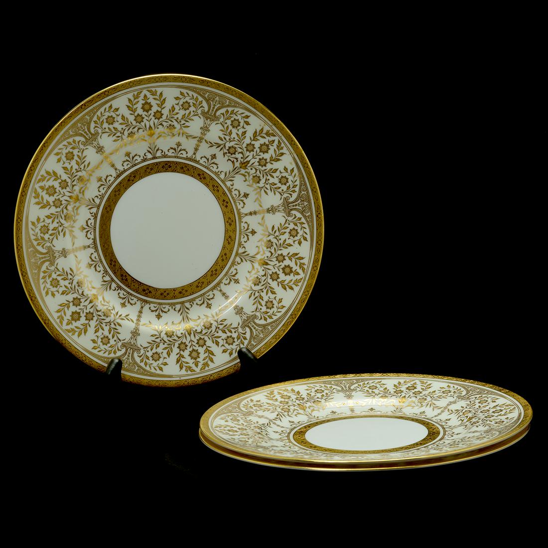 Set of Twelve Minton Gold and White Porcelain Dinner: Set of Twelve Minton Gold and White Porcelain Dinner Plates. Decorated with a gilt Neoclassical style architectural foliate motif on an ivory ground. Rouletted gilt banding around the outer and inner