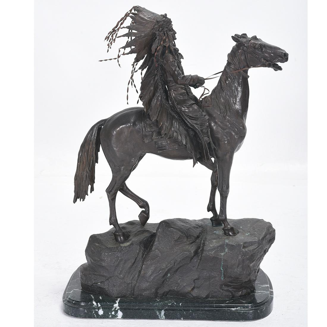 After Carl Kauba Indian Chief Bronze: After CARL KAUBA (Austrian 1865-1922) "Indian Chief on Horseback" Bronze. 8 1/2 x 19 x 26 inches. Including marble base: 10 x 20 x 28 inches. Numbered right top corner of bronze base: 23/100.