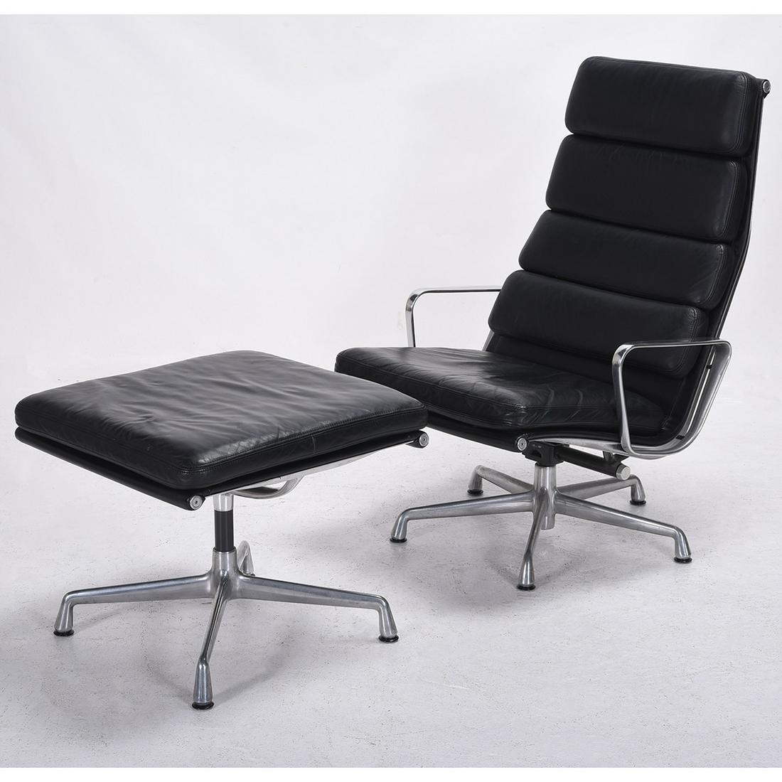 Charles and Ray Eames 438 Lounge Chair and 423 Ottoman.: Charles and Ray Eames 438 Lounge Chair and 423 Ottoman. Padded black leather lounge chair and ottoman with aluminum base. Labels to the underside. Circa 2000. {Approximate dimensions: Chair 39 high x 