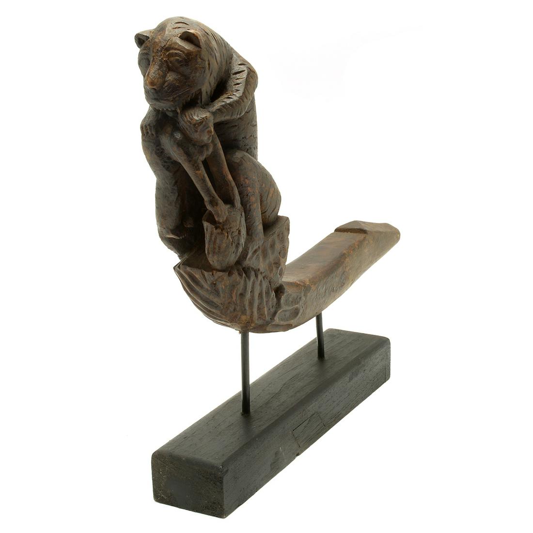 Nepalese Wood Carving, Crouching Tiger Devouring a Man.: Nepalese Wood Carving, Crouching Tiger Devouring a Man. On a black painted wood base. {Approximate dimensions including the base: 18 3/4 high x 18 inches long.}. Condition: Wear and patina to the wood
