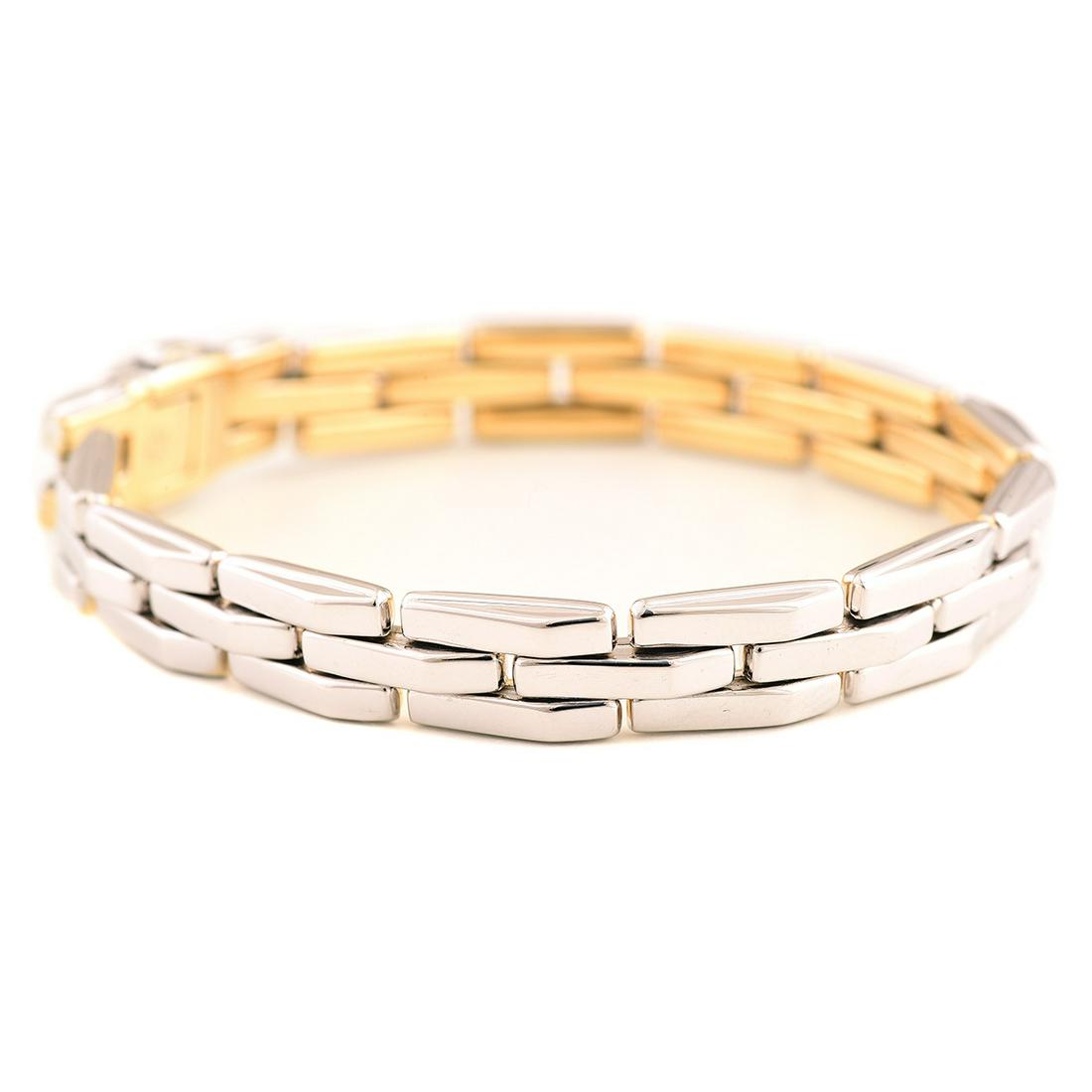 Chimento Diamond, 18k Gold Reversible Bracelet.: Chimento Diamond, 18k Gold Reversible Bracelet. The 18k reversible yellow and white gold brick link measuring approximately 9 mm in width, completed by a button snap clasp with a 0.03 ct. full-cut dia