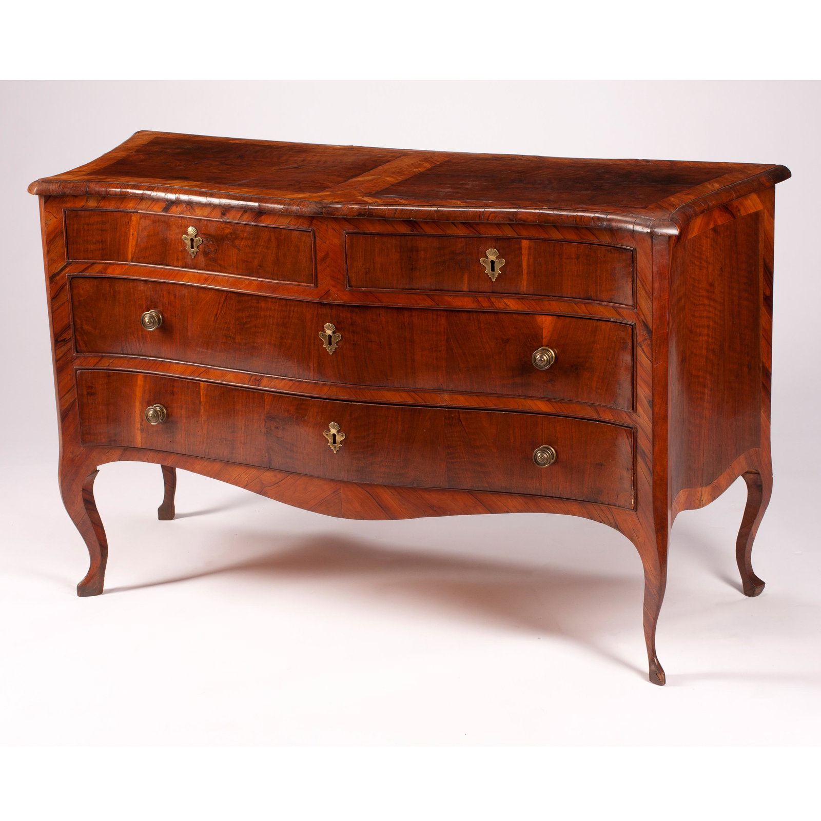 18th Century Italian Walnut Bombe Commode.: 18th Century Italian Walnut Bombe Commode. Shaped frame, two short over two long drawers, over modest cabriole legs. Unmarked. Italian. Circa 1790. {Approximate dimensions: 34 x 57 x 21 1/2 inches.}.