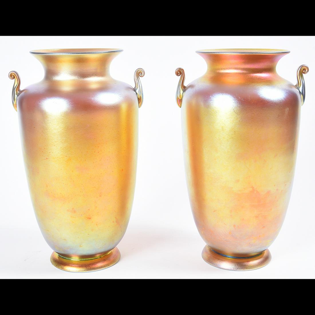 Pair of Steuben Glass Gold Aurene Vases.: Pair of Steuben Glass Gold Aurene Vases. Elongated baluster form, with spreading foot below the ankles, decorative handles to the sides. Both with broken pontils. One signed. One with Dremmel-type eng