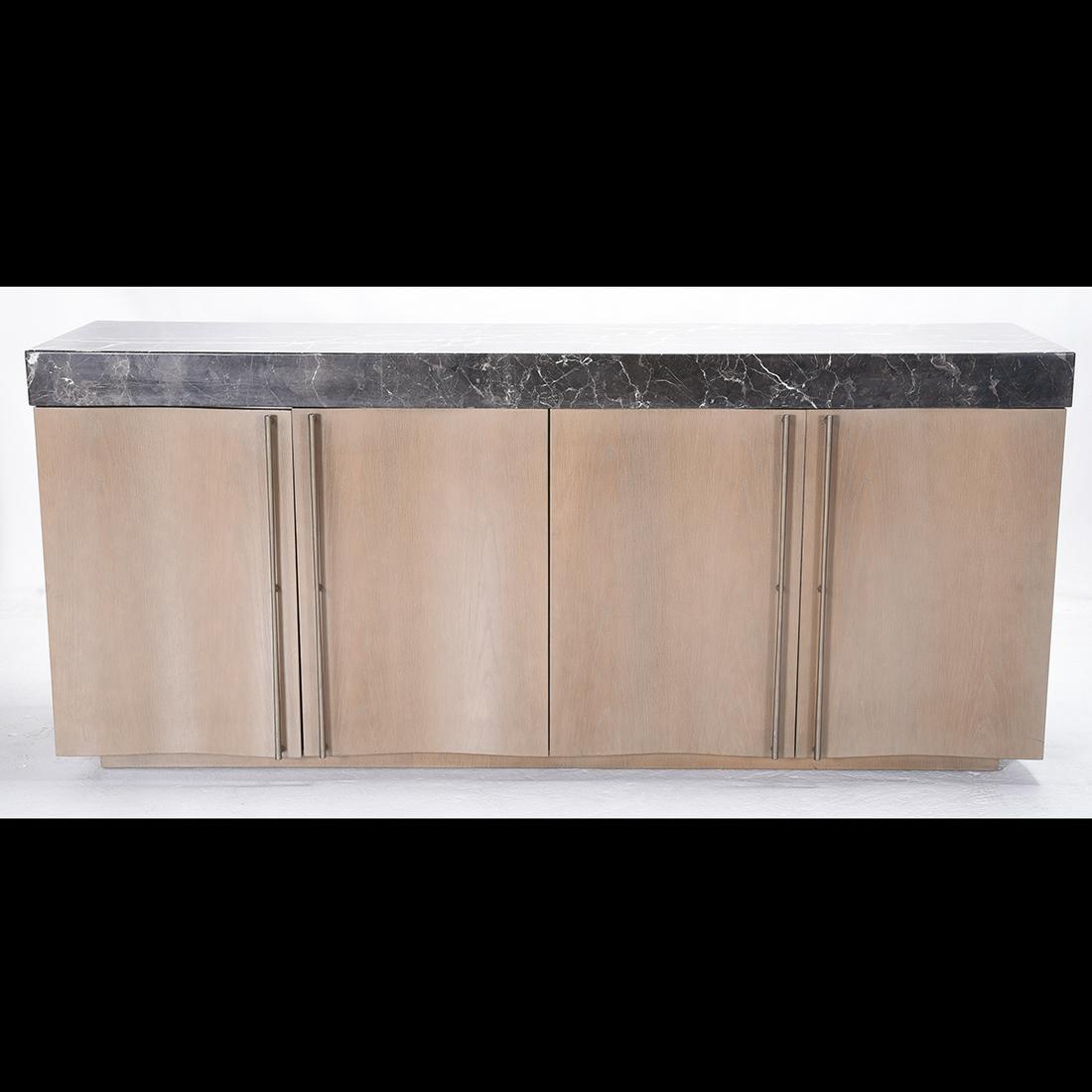 Donghia Sideboard with Black Marble Top.: Donghia Sideboard with Black Marble Top. Double serpentine front of green-grey cerused oak,with bronze-finish long bar handles, the top a bold slab of polished black and white marble. DONGHIA to inter