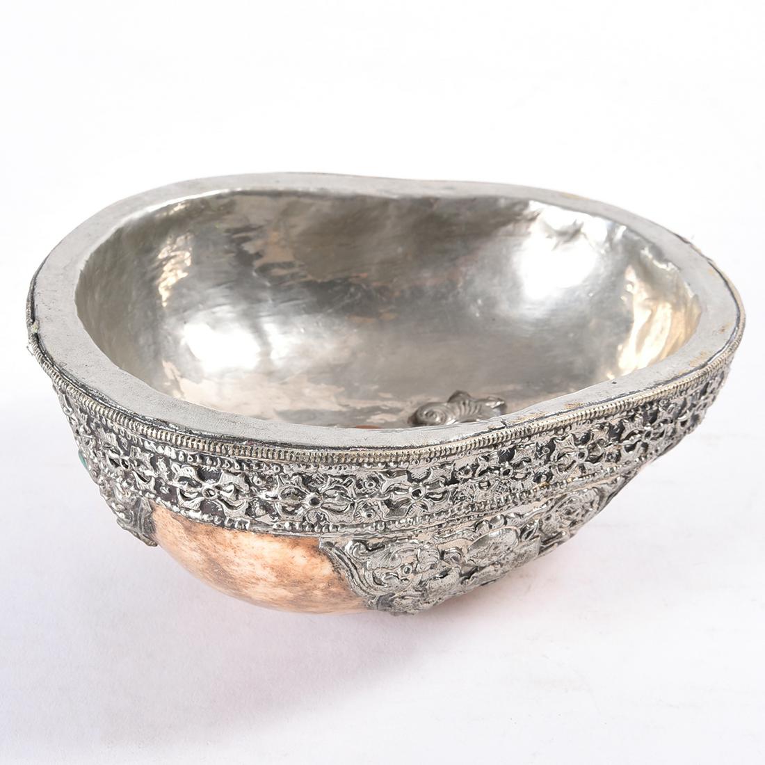 Indo-Tibetan Kapala, Ceremonial Skull Vessel.: Indo-Tibetan Kapala, Ceremonial Skull Vessel. Skull cap mounted with silver metal repousse, inset turquoise and coral. {Approximate dimensions: 2 1/2 high x 5 1/2 wide x 6 1/2 inches deep.}. Condition