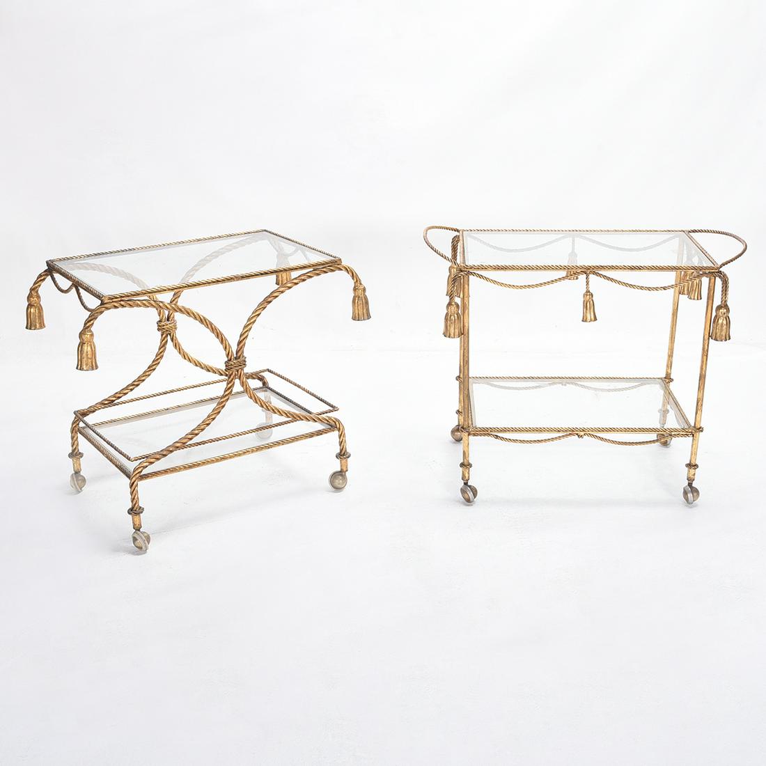 Two Gilt Metal Bar Carts with Rope and Tassel Motifs: Two Gilt Metal Bar Carts with Rope and Tassel Motifs. Both with inset glass tops and shelves. {Approximate dimensions: 25 1/2 -25 1/2 high x 32 1/2 -31 wide x 16 1/2-16 1/2 inches deep.}. Condition: M